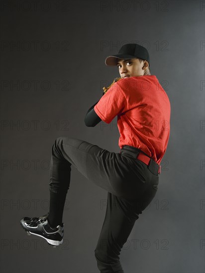 Mixed race baseball pitcher ready to pitch ball