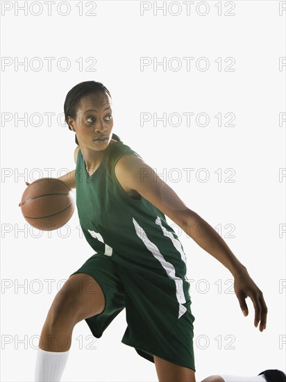 Mixed race woman playing basketball