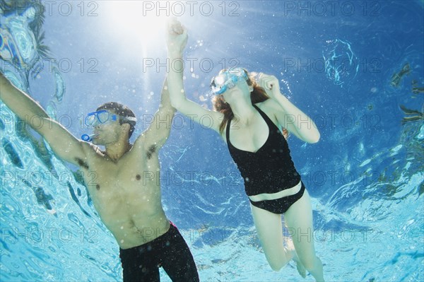 Couple swimming in swimming pool