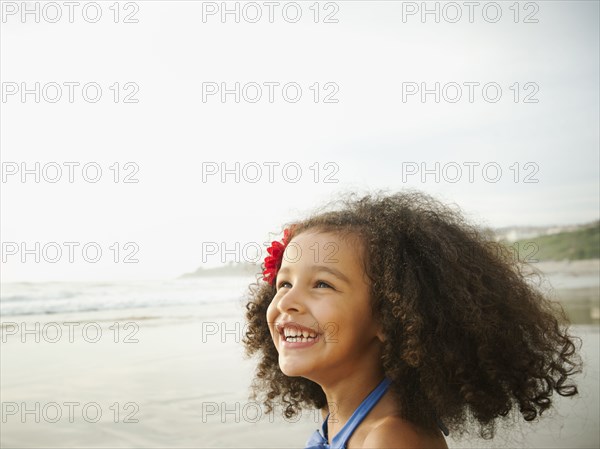 Smiling mixed race girl on beach