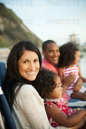 Family sitting together on beach