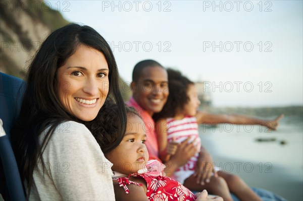 Family sitting together on beach