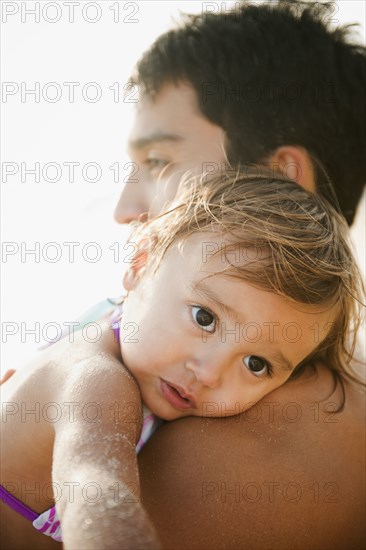 Mixed race father comforting daughter