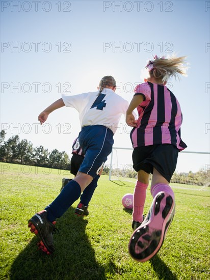 Caucasian girls playing soccer