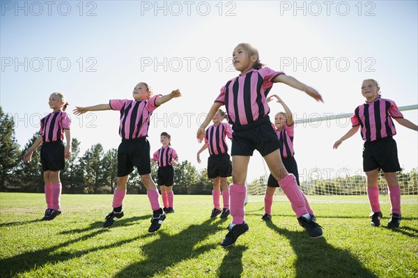 Caucasian girls warming up for soccer game