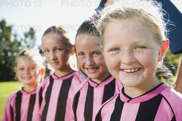 Caucasian girl soccer players smiling