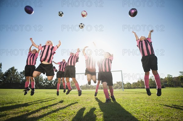 Girl soccer players practicing with soccer balls