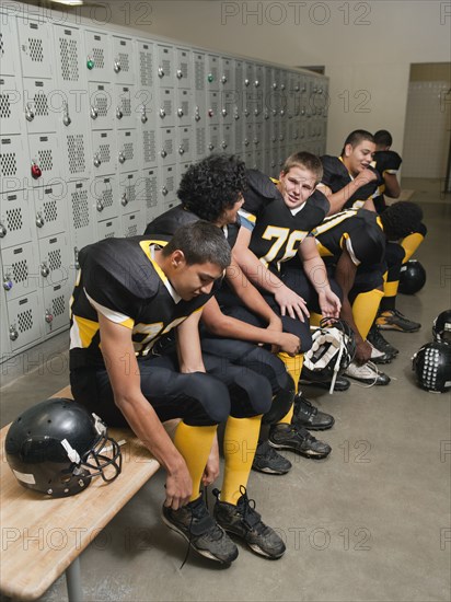 Football players dressing in locker room