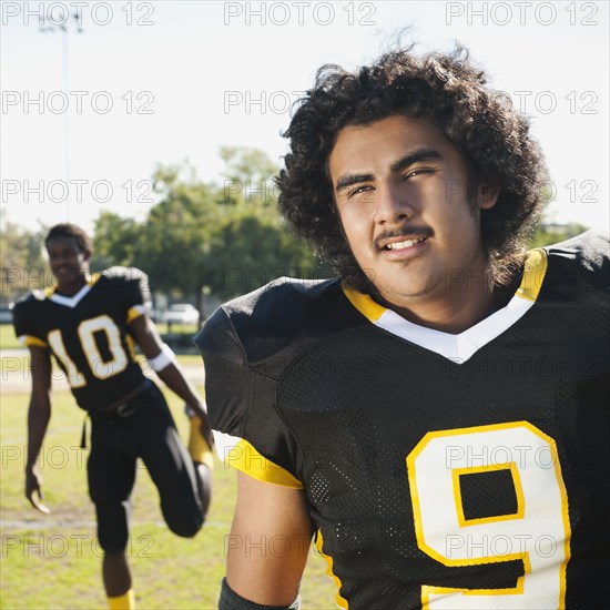 Football players stretching on football field