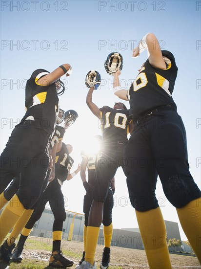 Football players celebrating on football field