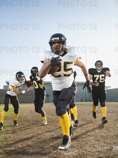 Football players playing on football field