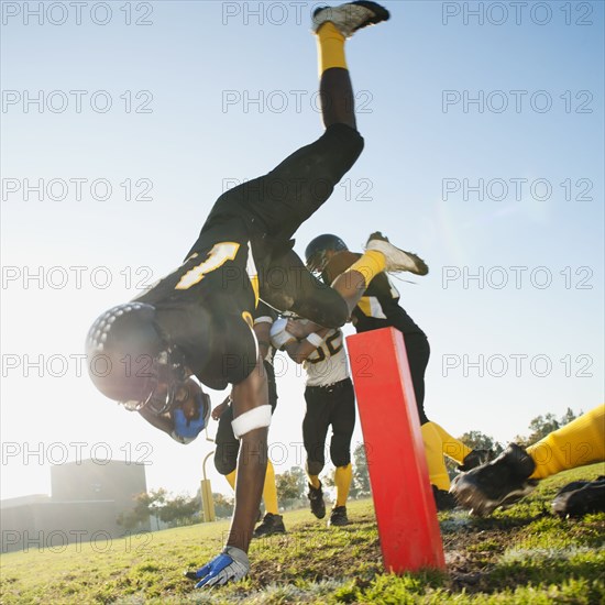 Football player scoring goal on football field