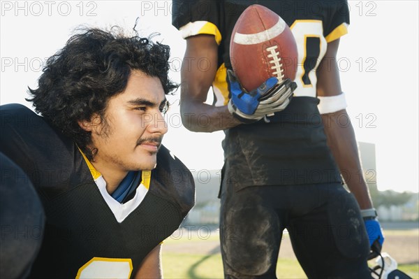 Football players together on football field