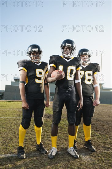 Football players standing on football field