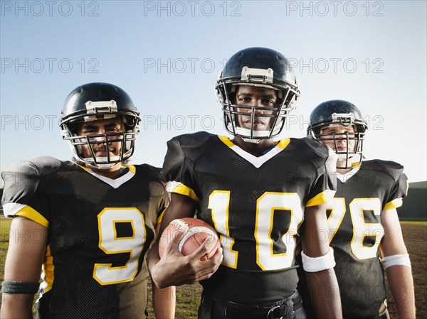 Football players standing on football field