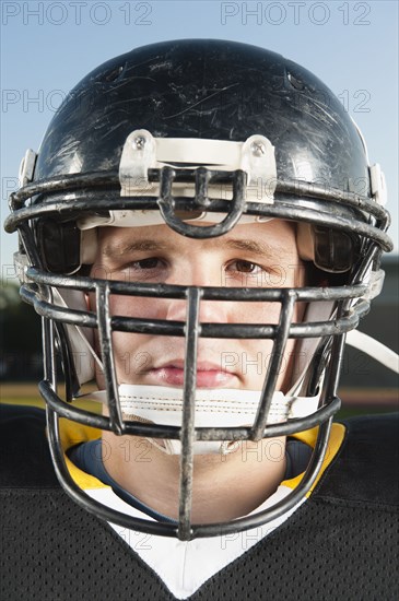 Serious Caucasian football player in helmet