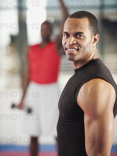 Mixed race man exercising in health club