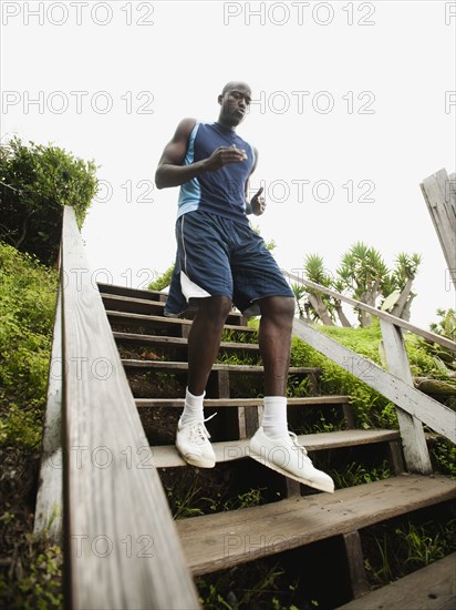 Black man running down stairs for exercise