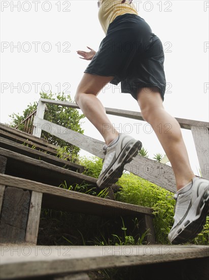 Caucasian woman running up stairs for exercise