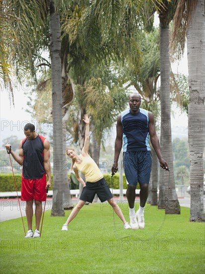 People exercising in park together