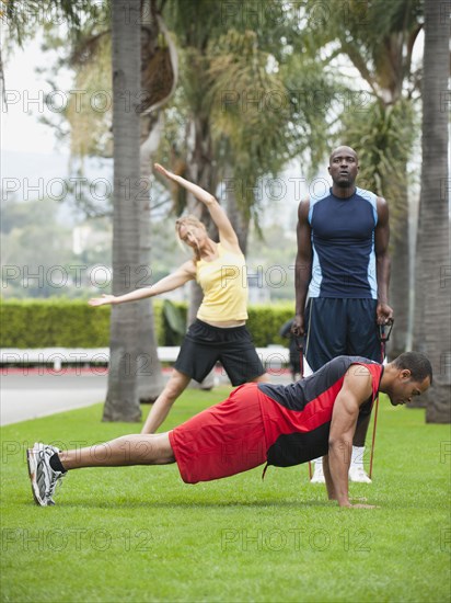 People exercising in park together