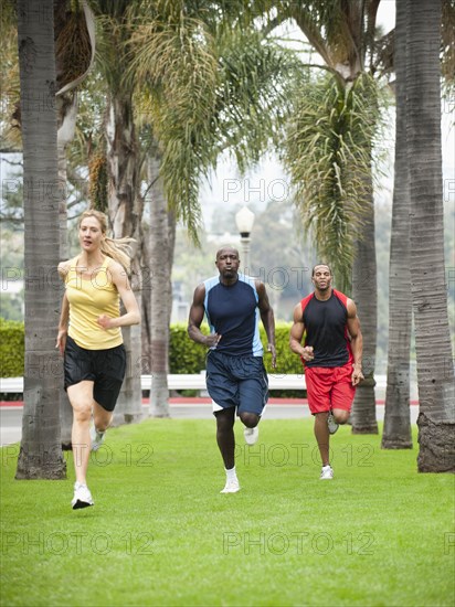People running in park together