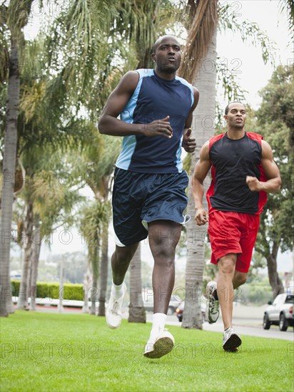 Men running in park together