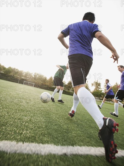 Men playing soccer on soccer field