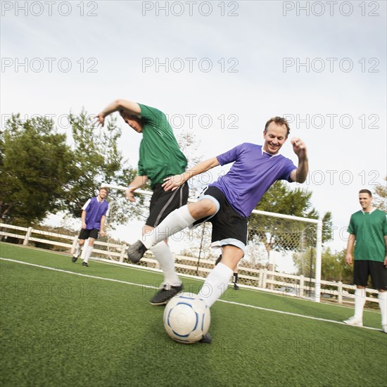 Men playing soccer on soccer field