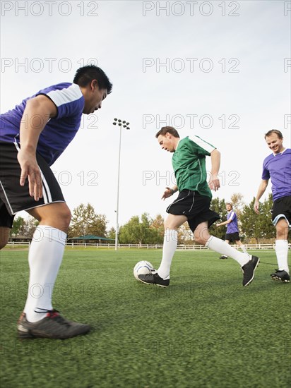 Men playing soccer on soccer field