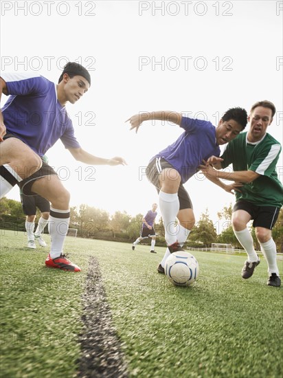 Men playing soccer on soccer field