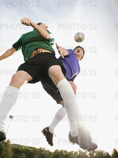 Soccer players heading soccer ball