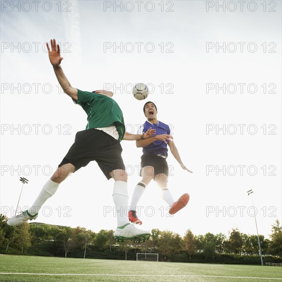 Soccer players heading soccer ball