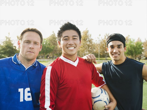 Smiling soccer players with ball