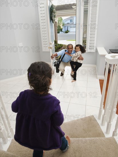 Daughters greeting returning father