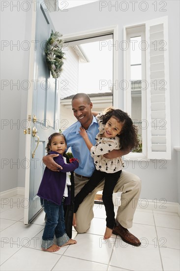 Daughters greeting returning father