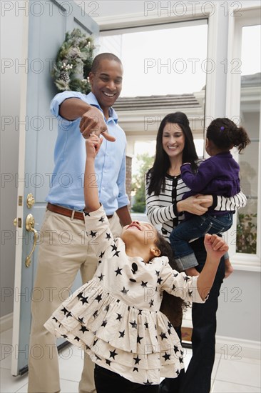 Father dancing with daughter in doorway