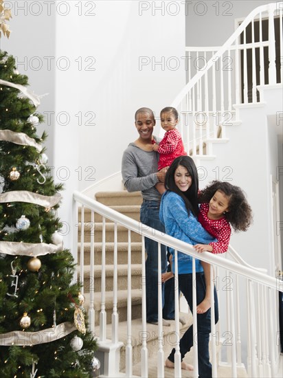 Family descending stairs on Christmas morning