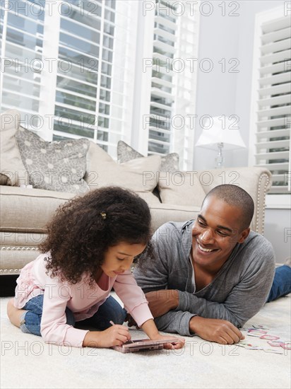 Father watching daughter play video game