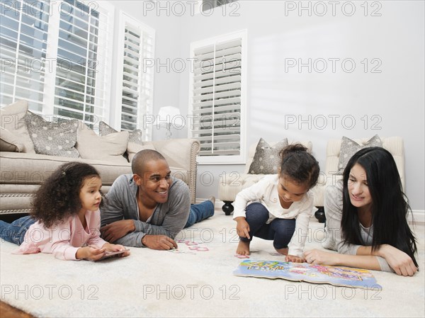 Family relaxing on living room floor