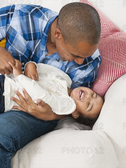 Father tickling daughter