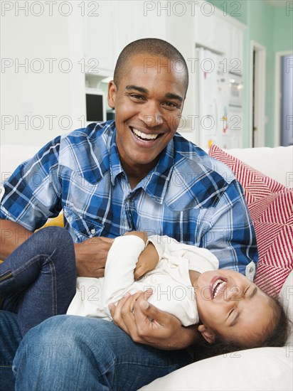 Father tickling daughter