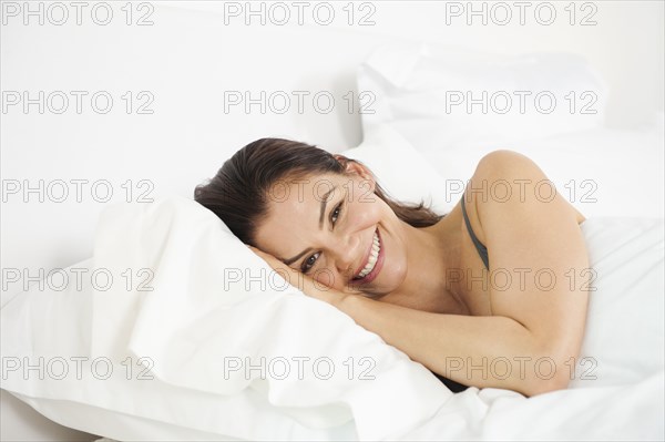 Mixed race woman laying in bed