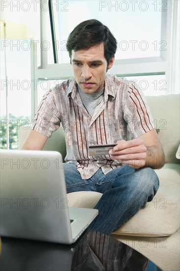 Caucasian man shopping online with credit card