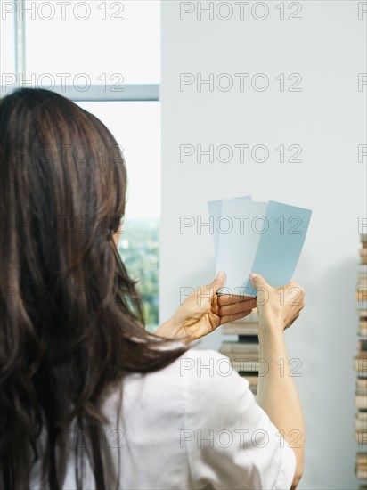 Mixed race woman looking at color swatches