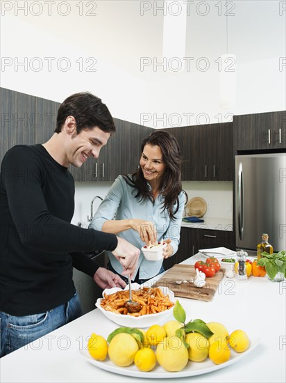 Couple making dinner together in kitchen