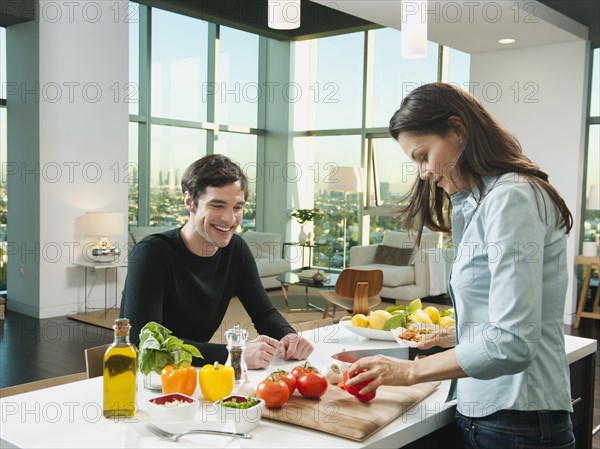 Couple making dinner together in kitchen