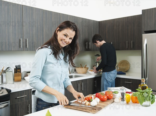 Couple making dinner together in kitchen