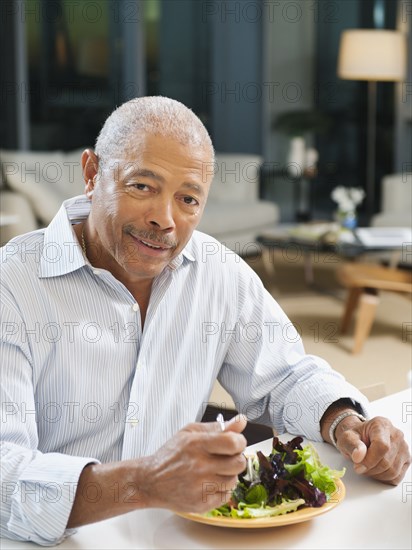 Black man eating salad