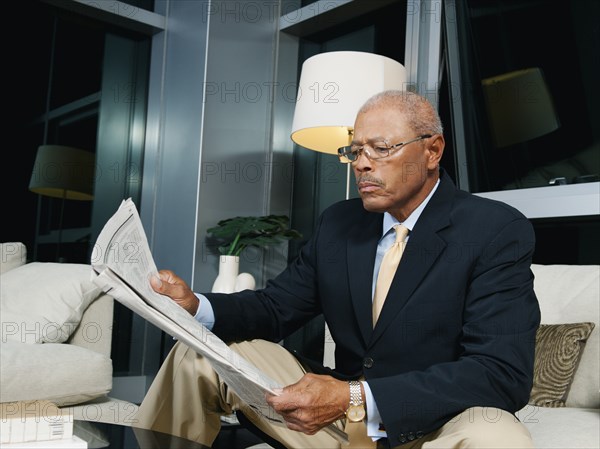 Black businessmen reading newspaper